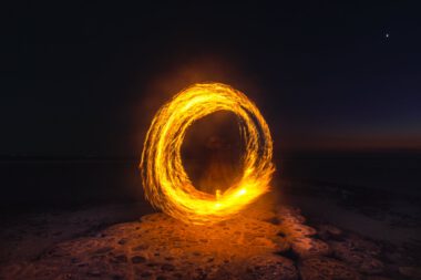 person performing fire dance at night